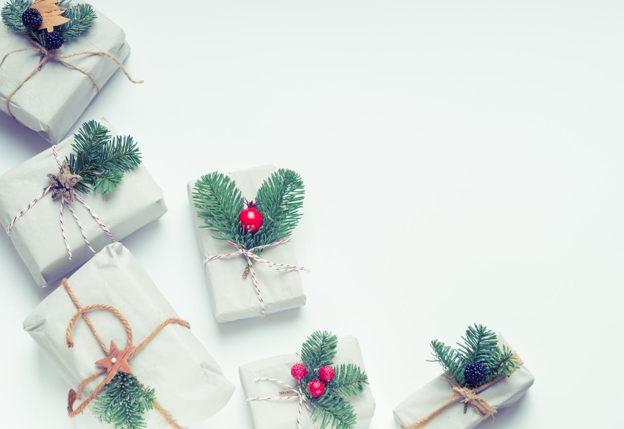 Minimalist Christmas gift boxes adorned with natural elements like pine branches and twine, perfect for holiday inspiration.